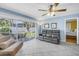 Cozy living room with screened patio access and a view into the adjacent bedroom at 13000 90Th Ave, Seminole, FL 33776