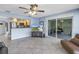 Open-concept living area with kitchen access and sliding door access to patio, perfect for entertaining at 13000 90Th Ave, Seminole, FL 33776