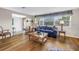 Comfortable living room features hardwood floors, a cozy couch, and access to the front entrance at 13000 90Th Ave, Seminole, FL 33776