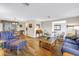 Bright living room features hardwood floors, neutral paint, and a cozy seating arrangement with comfortable furniture at 13000 90Th Ave, Seminole, FL 33776