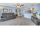 Comfortable living room with tile floors, leather sofa, and a view of the adjacent kitchen at 13000 90Th Ave, Seminole, FL 33776