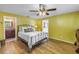 Bright bedroom featuring hardwood floors, ceiling fan, and adjoining bathroom access at 13000 90Th Ave, Seminole, FL 33776