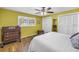 Comfortable bedroom with wood-look floors, closet, and ample natural light from the window at 13000 90Th Ave, Seminole, FL 33776