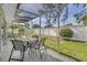 Serene screened-in patio with ample seating space overlooks the backyard at 13000 90Th Ave, Seminole, FL 33776