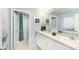 Bright bathroom featuring double sinks, white cabinetry and coordinated decorations at 13576 Tropical Breeze Way, Hudson, FL 34669