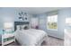 Bright and airy bedroom with neutral walls, patterned roman shade, and side table decor at 13576 Tropical Breeze Way, Hudson, FL 34669