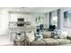 Inviting living room featuring open concept dining area, stylish decor, and lots of natural light at 13576 Tropical Breeze Way, Hudson, FL 34669