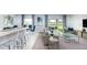 Modern open-concept living space with kitchen island, comfortable seating, and sliding glass doors at 13576 Tropical Breeze Way, Hudson, FL 34669