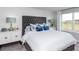 Relaxing main bedroom with plush carpeting, custom headboard, and large windows at 13576 Tropical Breeze Way, Hudson, FL 34669