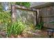Backyard water feature adds tranquil ambiance amidst the lush greenery and privacy fence at 1402 E Mohawk Ave, Tampa, FL 33604