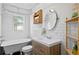 Renovated bathroom showcasing subway tile, modern vanity, and a vintage clawfoot tub at 1402 E Mohawk Ave, Tampa, FL 33604