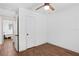 Bedroom with ceiling fan and hardwood floors; bathroom access through doorway at 1402 E Mohawk Ave, Tampa, FL 33604