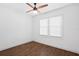 Bedroom featuring hardwood flooring and bright natural lighting from the window at 1402 E Mohawk Ave, Tampa, FL 33604