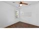 Bedroom with bright window and neutral walls, featuring dark stained hardwood flooring at 1402 E Mohawk Ave, Tampa, FL 33604