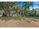 Charming single-story home with lush landscaping and a welcoming brick pathway at 1402 E Mohawk Ave, Tampa, FL 33604