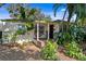 Charming front porch with a swing and tiled steps, surrounded by lush greenery at 1402 E Mohawk Ave, Tampa, FL 33604