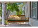 Cozy front porch featuring a wooden swing, perfect for relaxing outdoors at 1402 E Mohawk Ave, Tampa, FL 33604