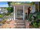 Inviting front porch with a swing and decorative tiled steps and pillar at 1402 E Mohawk Ave, Tampa, FL 33604