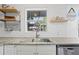 View of the kitchen sink and granite countertops with white shaker style cabinets at 1402 E Mohawk Ave, Tampa, FL 33604