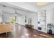 Bright living room featuring wood-look tile floors, rattan sofa, built-in shelving, and plenty of natural light at 1402 E Mohawk Ave, Tampa, FL 33604