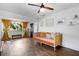 Bright living room showcasing wood-look tile floors, natural light, and views of tropical outdoor foliage at 1402 E Mohawk Ave, Tampa, FL 33604