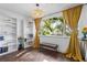 Bright living room boasts hardwood floors, built-in shelving, bench seating, and ample natural light at 1402 E Mohawk Ave, Tampa, FL 33604
