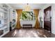 Bright living room features hardwood floors, built-in shelving, large window, and stylish decor at 1402 E Mohawk Ave, Tampa, FL 33604