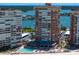 Aerial view of condo towers showing pool, and parking, with tranquil water views in the background at 17920 Gulf Blvd # 1901, Redington Shores, FL 33708