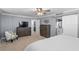 Comfortable bedroom featuring neutral carpet, dresser, television, and ensuite bathroom at 17920 Gulf Blvd # 1901, Redington Shores, FL 33708
