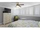 Bright bedroom features plantation shutters, ceiling fan, comfortable armchair, and a storage dresser at 17920 Gulf Blvd # 1901, Redington Shores, FL 33708