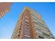 Low angle of a tall condominium building showcasing architectural details against a blue sky at 17920 Gulf Blvd # 1901, Redington Shores, FL 33708