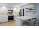 Modern kitchen features white cabinets, stainless steel appliances, and marble countertops at 17920 Gulf Blvd # 1901, Redington Shores, FL 33708