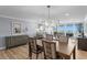 Open-concept living and dining area featuring modern furnishings, stylish decor and a water view at 17920 Gulf Blvd # 1901, Redington Shores, FL 33708