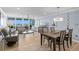 Bright, open-plan living space with dining area, comfortable seating and expansive windows showcasing water views at 17920 Gulf Blvd # 1901, Redington Shores, FL 33708