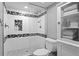 Updated shower featuring sleek glass enclosure, modern fixtures and decoratively tiled accent border at 17920 Gulf Blvd # 1901, Redington Shores, FL 33708