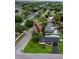 An aerial view highlights a well-maintained home with lush landscaping and a private swimming pool at 1873 Murray Ave, Clearwater, FL 33755