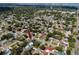 Expansive aerial shot displaying the property nestled in a lush, established neighborhood with cityscape in the background at 1873 Murray Ave, Clearwater, FL 33755
