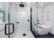 Spa-like bathroom with luxurious soaking tub, seamless glass shower, and modern fixtures on dark flooring at 1873 Murray Ave, Clearwater, FL 33755