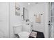 Stylish bathroom with modern fixtures, decorative mirror, and glass shower entry toliet at 1873 Murray Ave, Clearwater, FL 33755