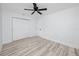 Clean, modern bedroom with wood-look floors, a contemporary ceiling fan, and a spacious closet at 1873 Murray Ave, Clearwater, FL 33755