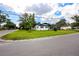 Street-level view of a charming single-story home with a lush green lawn and a neatly kept yard at 1873 Murray Ave, Clearwater, FL 33755