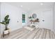 Bright hallway with stylish console table decor and an open door to a backyard pool area at 1873 Murray Ave, Clearwater, FL 33755