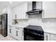 Modern kitchen with stainless steel appliances, white cabinets, and quartz countertops at 1873 Murray Ave, Clearwater, FL 33755
