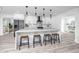 Modern kitchen with white cabinets, a quartz countertop island with seating, and pendant lighting at 1873 Murray Ave, Clearwater, FL 33755