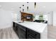 Open-concept kitchen and living room with modern finishes, stainless steel appliances, and hardwood-style floors at 1873 Murray Ave, Clearwater, FL 33755