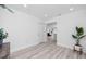 Bright and airy living room with modern flooring, neutral walls, and an open doorway to other areas at 1873 Murray Ave, Clearwater, FL 33755