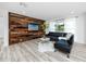 Bright living room with a statement wood wall, stylish seating, and minimalist decor at 1873 Murray Ave, Clearwater, FL 33755