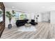 Bright living room with sleek furnishings, hardwood-style floors, and a minimalist design at 1873 Murray Ave, Clearwater, FL 33755