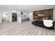 Modern living room and kitchen area with sleek furniture, minimalist decor, and wood-style flooring at 1873 Murray Ave, Clearwater, FL 33755