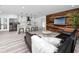 Modern living room and kitchen with sleek finishes, stylish furnishings, and hardwood-style floors at 1873 Murray Ave, Clearwater, FL 33755